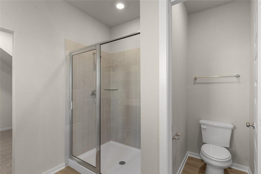 Bathroom featuring a shower stall, recessed lighting, and light wood-type flooring