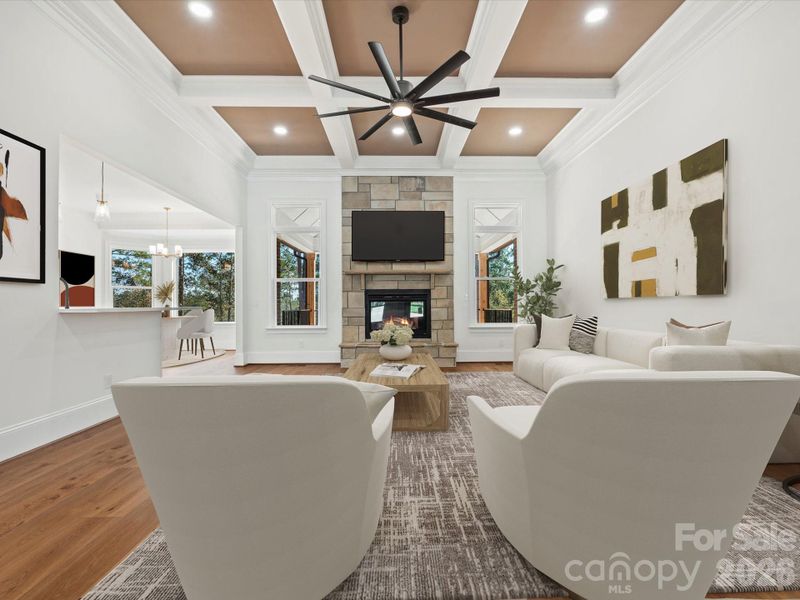 Great room with soaring, coffered ceilings and fireplace