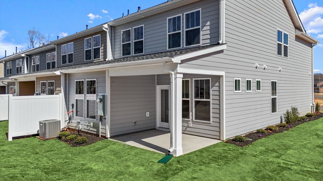 Exceptional outdoor living begins with a covered back porch in this thoughtfully designed townhome in Greenville, SC