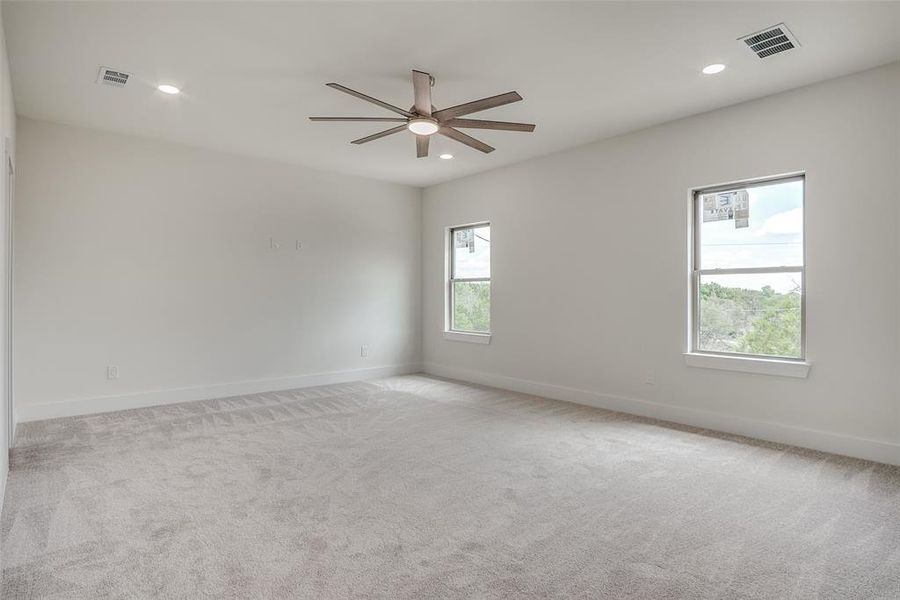 Spare room with ceiling fan, recessed lighting, and light colored carpet Spare room with ceiling fan, recessed lighting, and light colored carpet