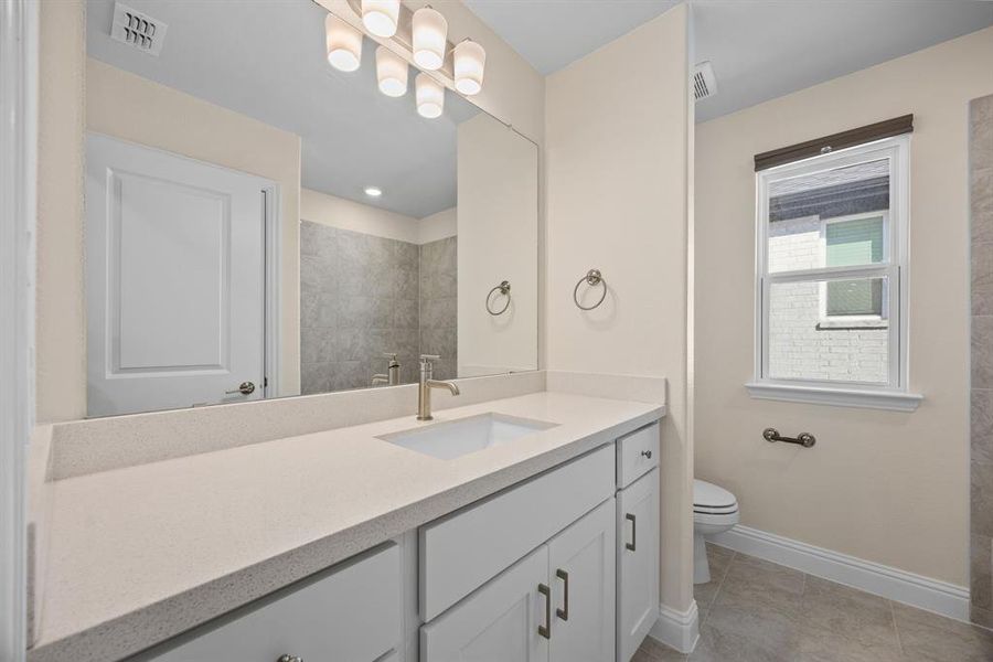 2nd level Full bathroom featuring vanity and light tile patterned floors