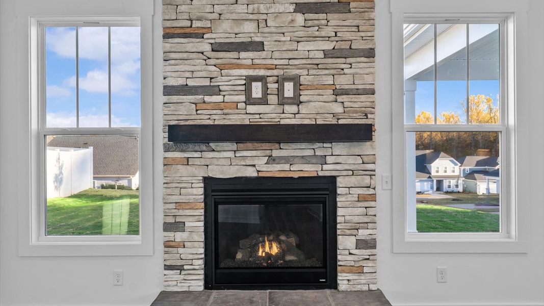 First-class family room with stone fireplace offering comfort and style with an elegant balance of space and detail