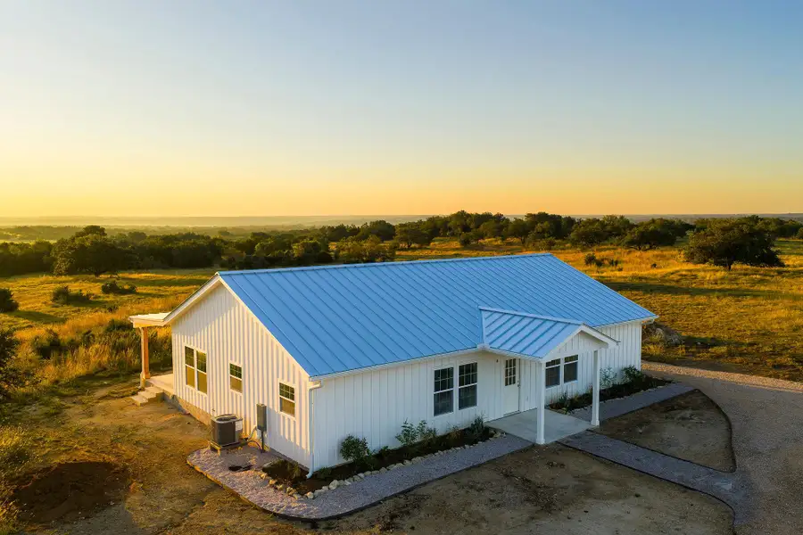 View of front facade featuring a standing seam roof, a porch, board and batten siding, and a metal roof View of front facade featuring a standing seam roof, a porch, board and batten siding, and a metal roof