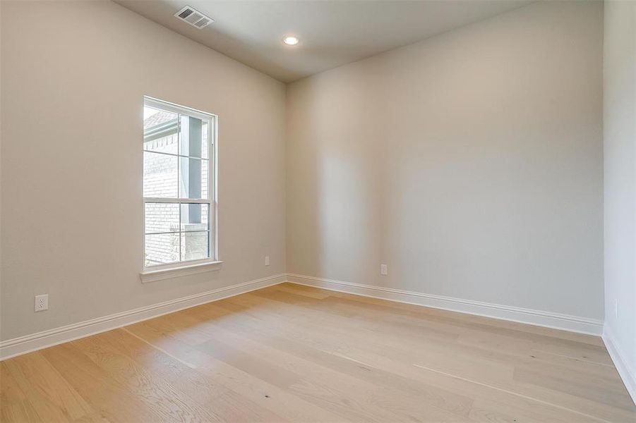 Unfurnished room with a wealth of natural light and light wood-type flooring