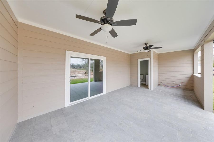 Living room doors open to the backyard, seamlessly blending indoor and outdoor spaces for effortless entertaining and relaxation.