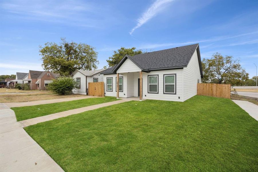 Welcome home featuring a shingled roof & front porch.
