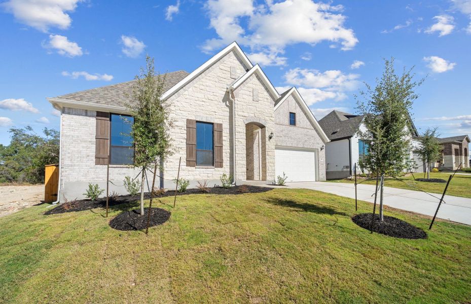 Front exterior of a new home in 6 Creeks, Kyle, TX, highlighting curb appeal (Image 27). Front exterior of a new home in 6 Creeks, Kyle, TX, highlighting curb appeal (Image 27).