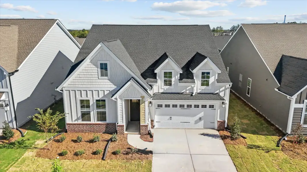 Front exterior of a new home in Ovation at Sweetbrier, Durham, NC, highlighting curb appeal (Image 1). Front exterior of a new home in Ovation at Sweetbrier, Durham, NC, highlighting curb appeal (Image 1).