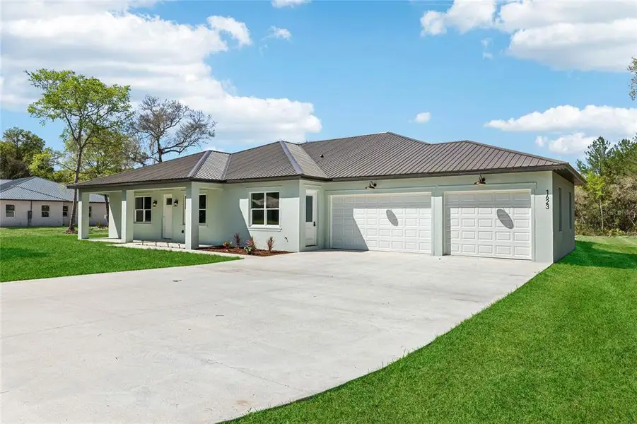 Front exterior of a new home in , Deltona, FL, highlighting curb appeal (Image 2). Front exterior of a new home in , Deltona, FL, highlighting curb appeal (Image 2).