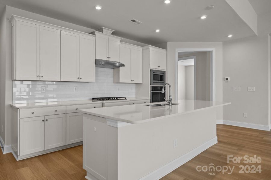 The chef in your family will love this Kitchen with quartz counters, ceramic tile backsplash, recessed lights, wall oven and upgraded cabinetry.