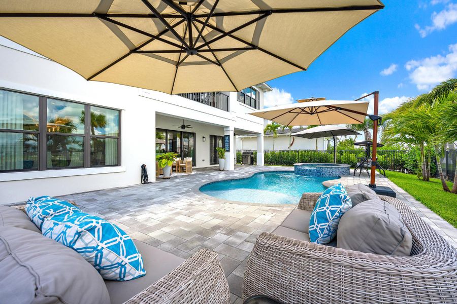 An extended pool deck for the heated pool and spa with privacy landscaping.