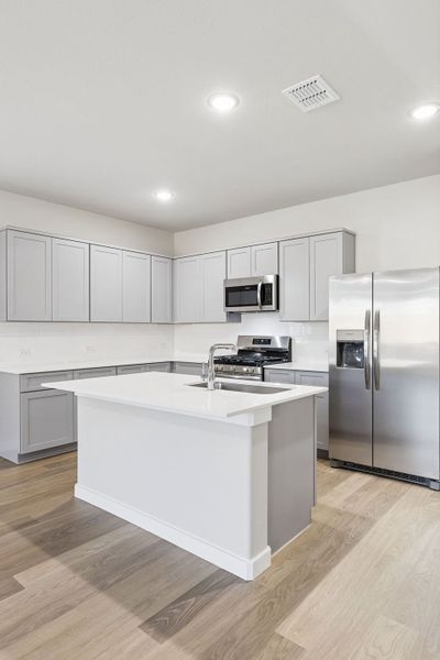 Kitchen in the Haylee home plan by Trophy Signature Homes - REPRESENTATIVE PHOTO Kitchen in the Haylee home plan by Trophy Signature Homes - REPRESENTATIVE PHOTO