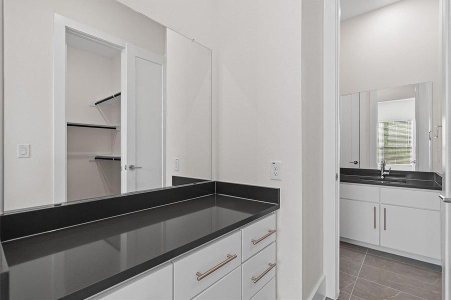 Full bath featuring vanity and light tile patterned floors Full bath featuring vanity and light tile patterned floors