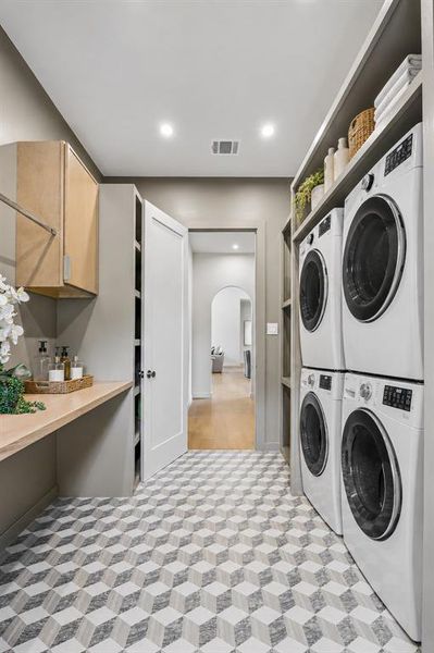 Double stacked washer and dryer connections for quick laundry days, coupled with ample storage as you enter from the garage.  Don't miss the side yard separate from the pool just off the laundry room!