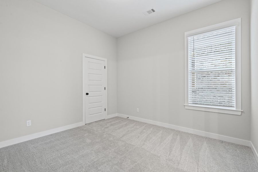 Unfurnished room with light carpet and baseboards