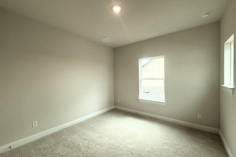 Neutral-toned room featuring light beige carpet, white baseboards, and a single-pane window with white trim Neutral-toned room featuring light beige carpet, white baseboards, and a single-pane window with white trim