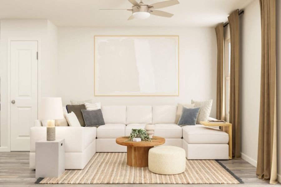A living room with a white couch and a white ceiling fan.
