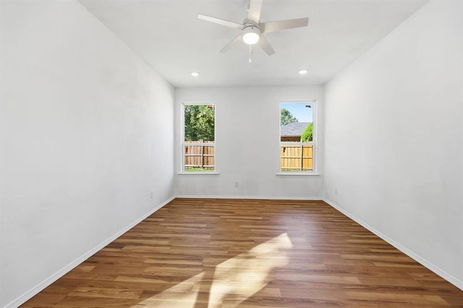 Primary bedroom featuring wood finished floors, recessed lighting, and ceiling fan