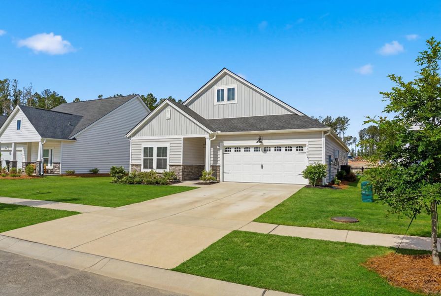 Front exterior of a new home in Horizons at Summers Corner | 55+, Summerville, SC, highlighting curb appeal (Image 29).