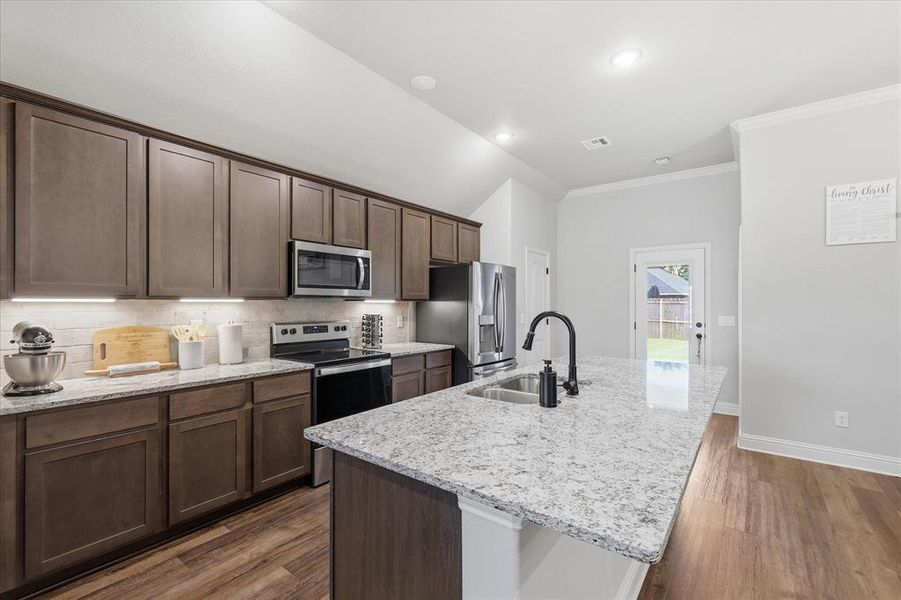 Well-appointed kitchen featuring a beautiful island that offers additional prep space, seating, and functionality.