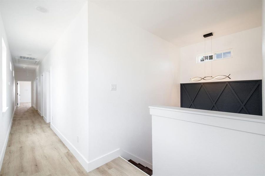 Corridor featuring baseboards and light wood-type flooring