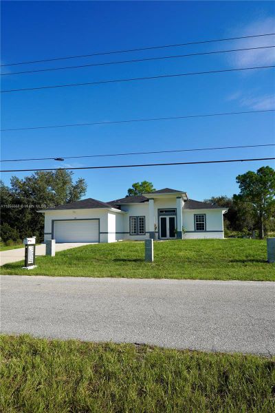Front exterior of a new home in , Lehigh Acres, FL, highlighting curb appeal (Image 2).