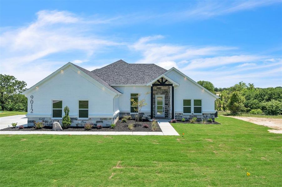 Front exterior of a new home in , Springtown, TX, highlighting curb appeal (Image 2).