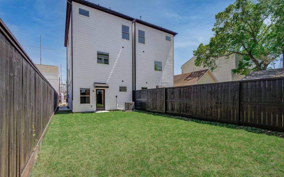 Modern townhomes featuring sleek lines, large windows, and spacious garages, set in a contemporary neighborhood.
