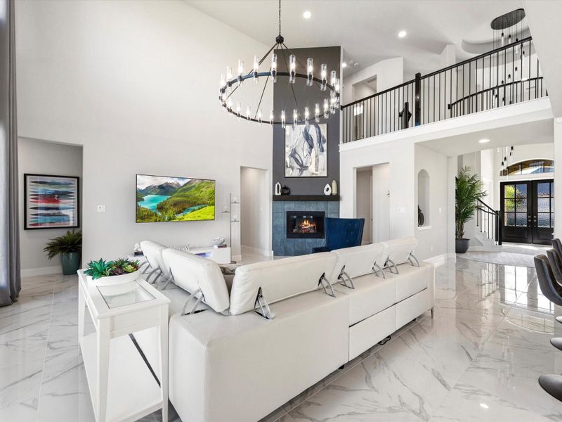 This large family room boasts a contemporary gas-log fireplace with tile surround. Notice the upstairs 'cat-walk' with modern wrought iron spindles, open to both sides. Tucked away in the back corner, that doorway on the left leads to your private sanctuary.