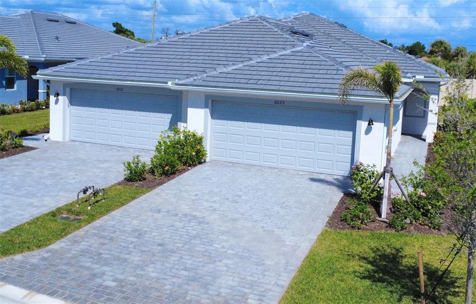 Front exterior of a new home in Palm Lake at Coco Bay, Englewood, FL, highlighting curb appeal (Image 2).