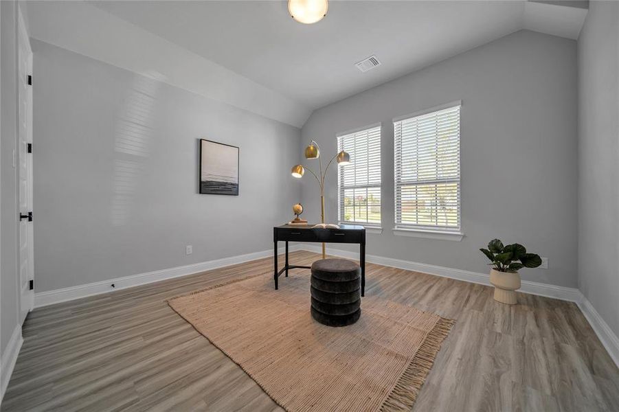 Office space with lofted ceiling and light wood-style flooring Office space with lofted ceiling and light wood-style flooring