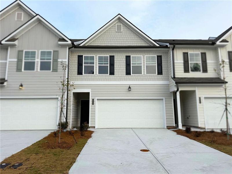 Front exterior of a new home in Rivershire Place, Villa Rica, GA, highlighting curb appeal (Image 24). Front exterior of a new home in Rivershire Place, Villa Rica, GA, highlighting curb appeal (Image 24).