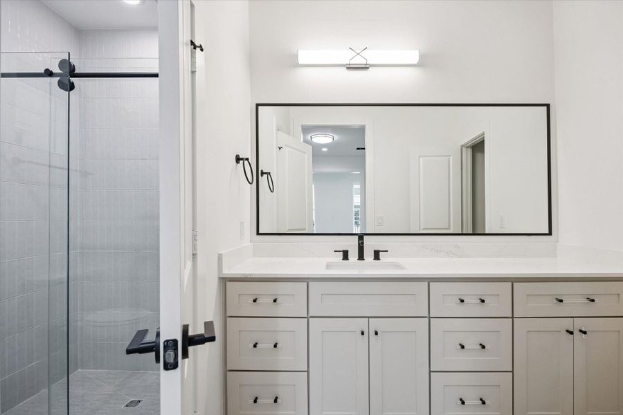 Secondary bathroom featuring an *upgraded walk-in shower in lieu of a traditional tub/shower combo for a sleek, modern feel.