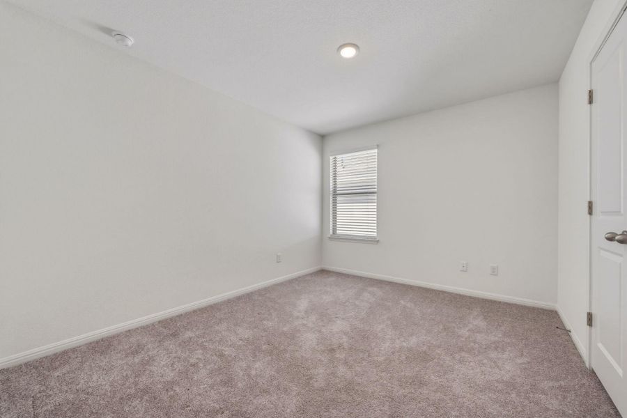 Unfurnished bedroom featuring carpet and baseboards