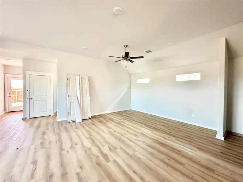Unfurnished bedroom featuring a ceiling fan, light wood-type flooring, and lofted ceiling Unfurnished bedroom featuring a ceiling fan, light wood-type flooring, and lofted ceiling