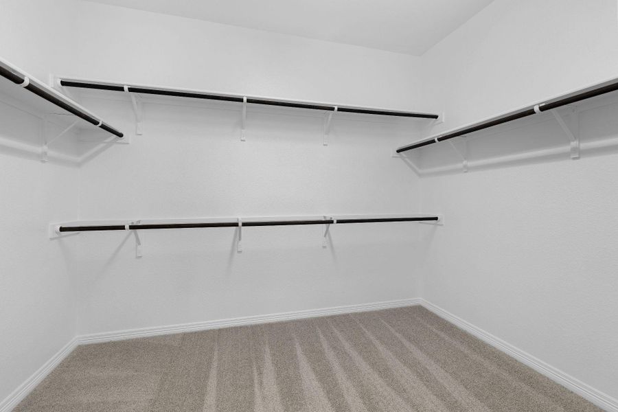 Walk-in closet in Primary Bedroom Walk-in closet in Primary Bedroom