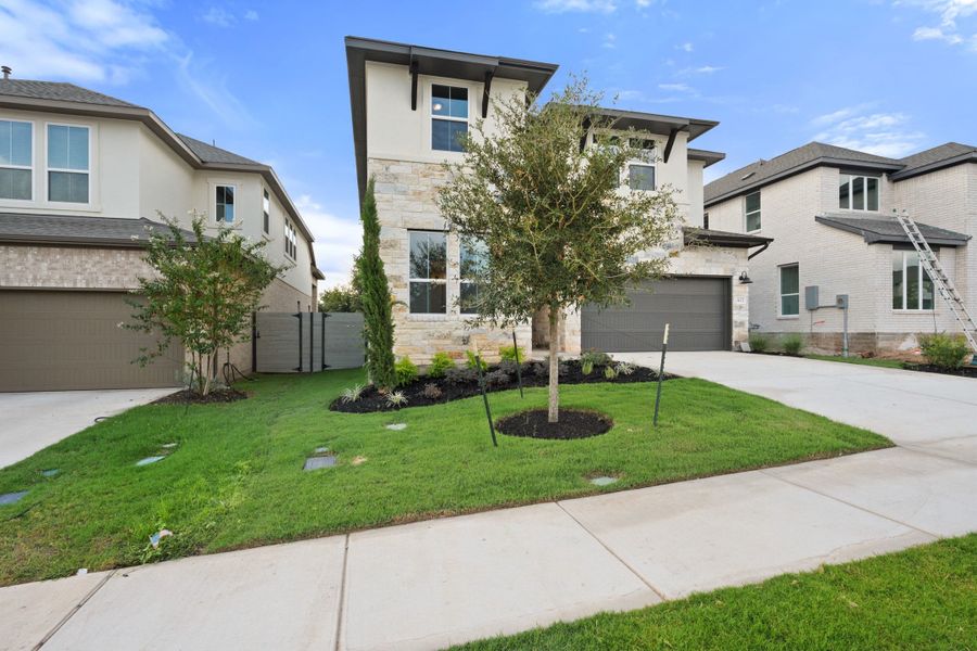 Front exterior of a new home in Wolf Ranch, Georgetown, TX, highlighting curb appeal (Image 24).