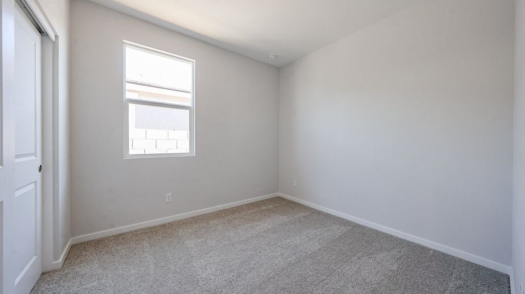 A room with a window and carpet. A room with a window and carpet.