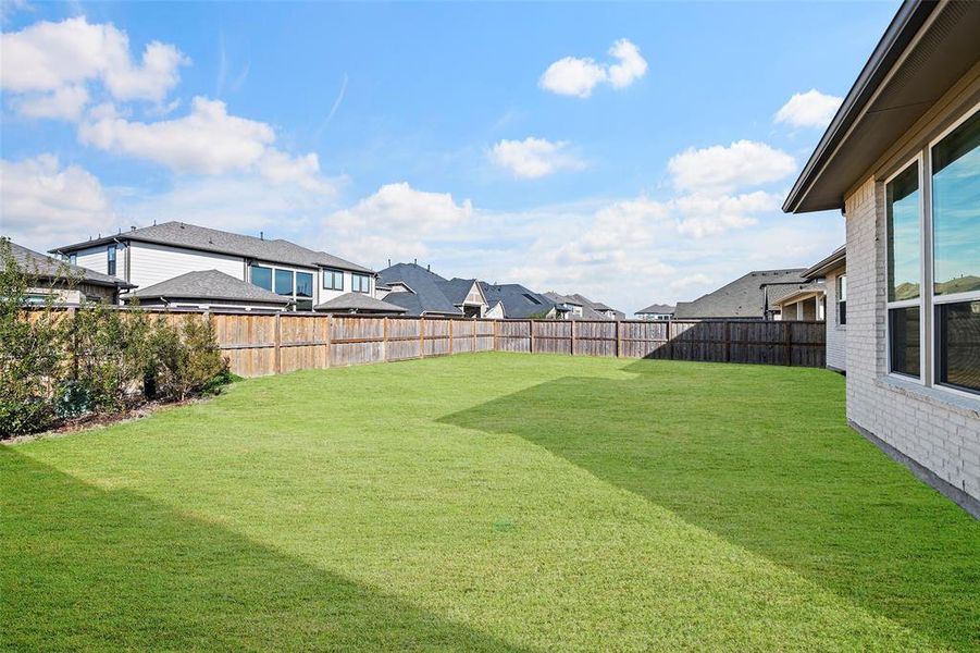 A view of the sizable back yard, a blank canvas for you!