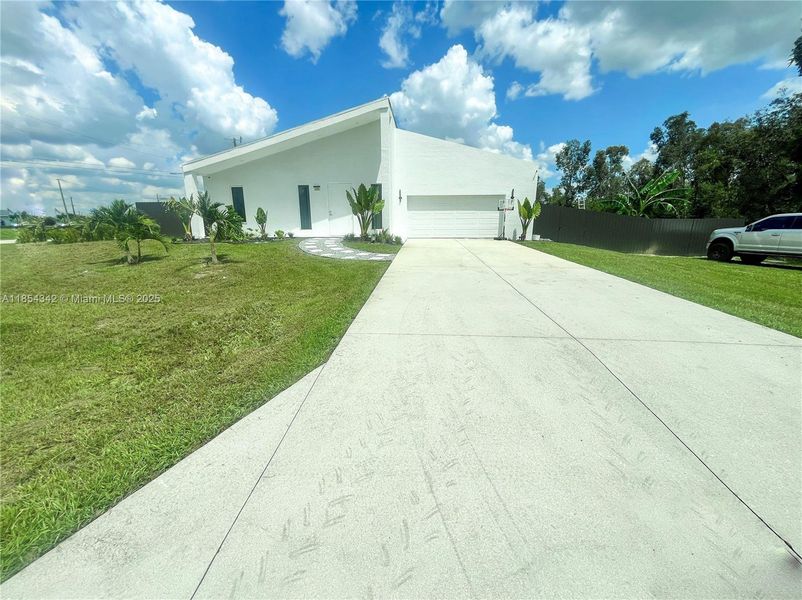 Front exterior of a new home in , Lehigh Acres, FL, highlighting curb appeal (Image 30). Front exterior of a new home in , Lehigh Acres, FL, highlighting curb appeal (Image 30).