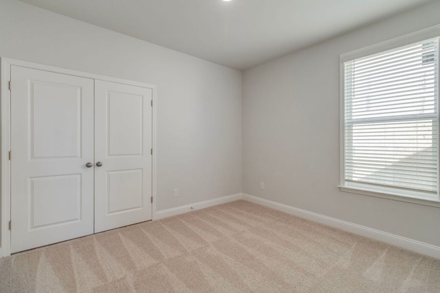 Cozy yet spacious, this secondary bedroom is designed with relaxation in mind.