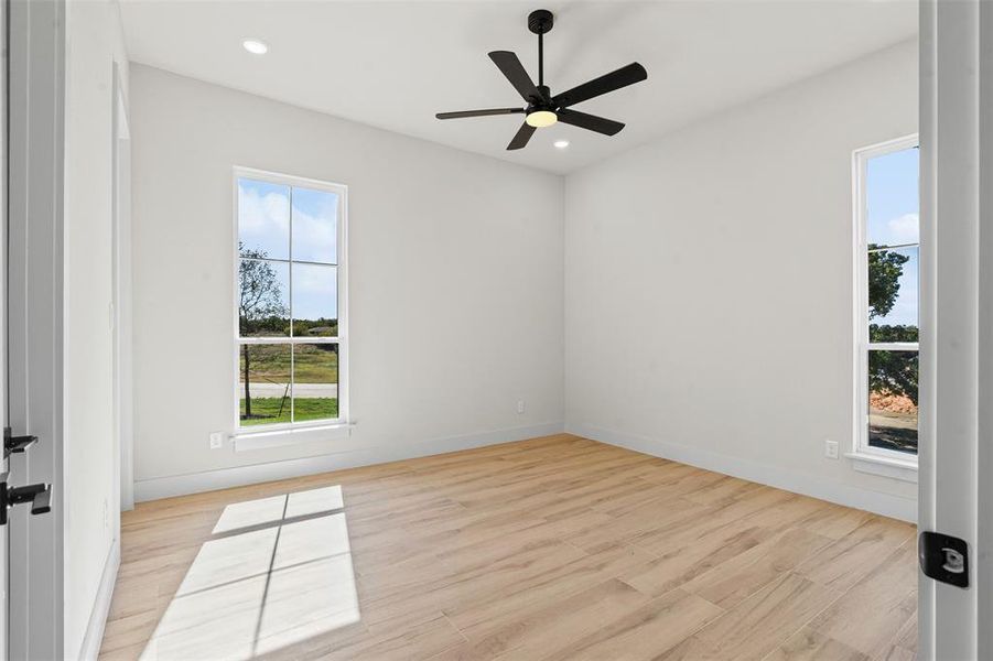 Empty room featuring light wood-style floors, recessed lighting, and a ceiling fan Empty room featuring light wood-style floors, recessed lighting, and a ceiling fan