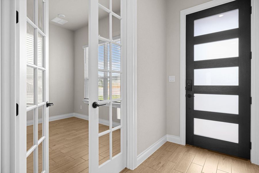 Foyer with light wood-style flooring and french doors