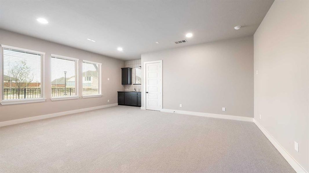 Unfurnished living room featuring carpet floors