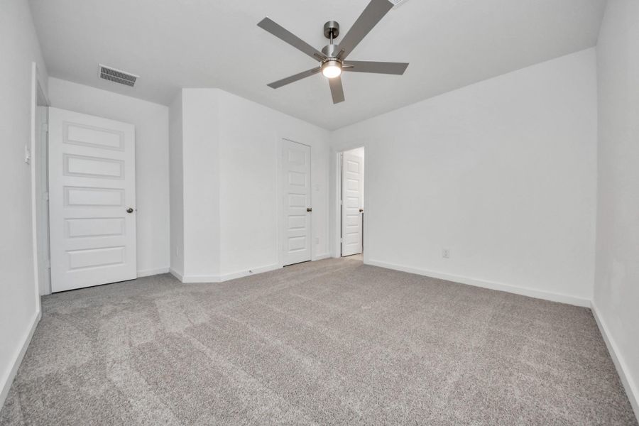 Generously sized secondary bedrooms featuring spacious closets, soft and inviting carpeting underfoot, large windows allowing plenty of natural light, and the added touch of privacy blinds for your personal retreat. Sample photo of completed home with similar floor plan. Actual colors and selections may vary.