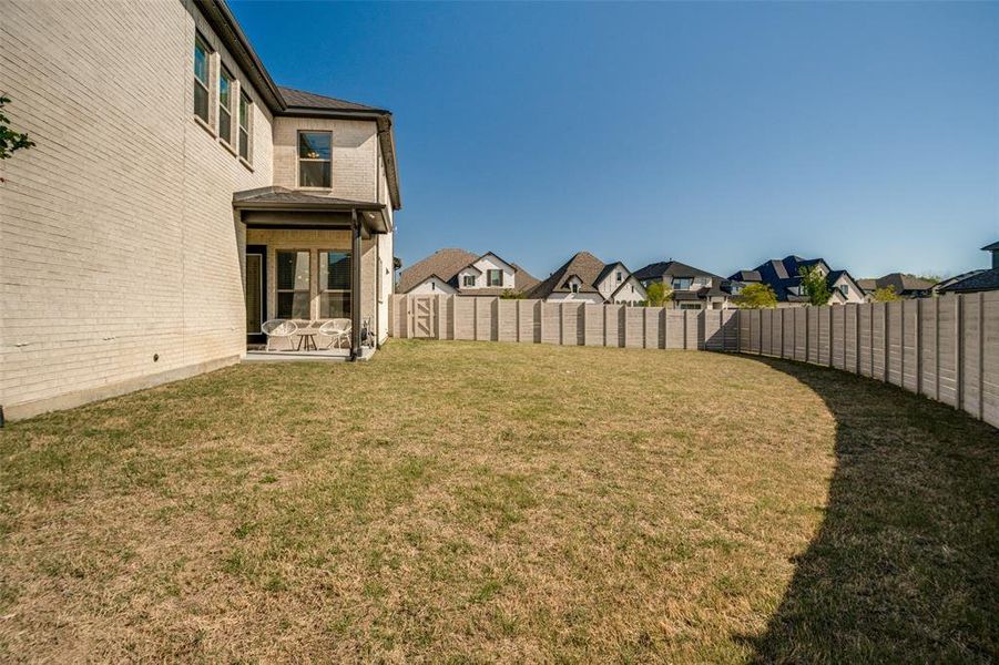 Fenced backyard featuring a residential view and a patio area