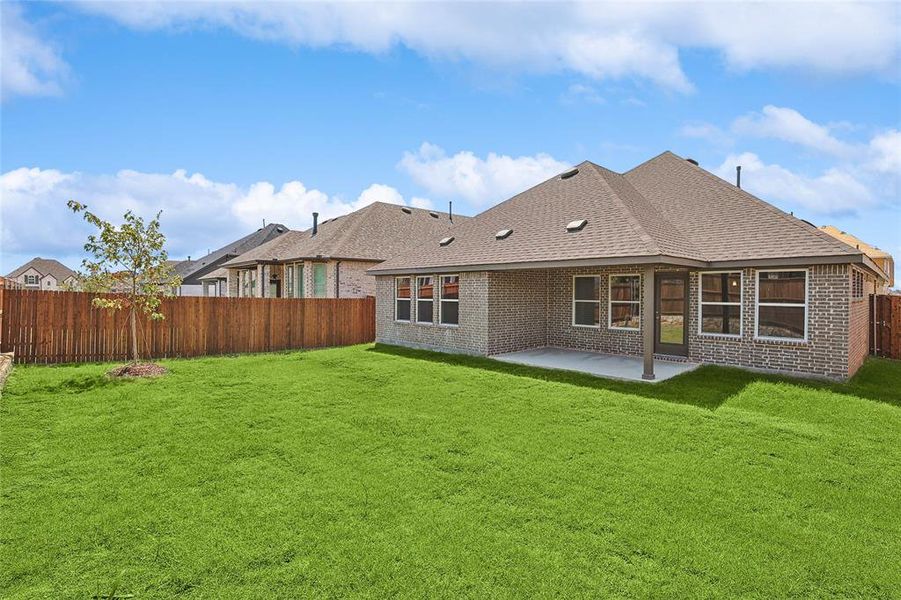 Back of house featuring a patio and a yard