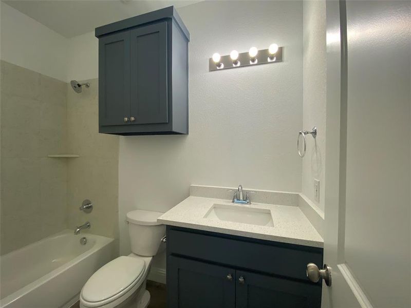 Full bathroom featuring vanity and bathtub / shower combination Full bathroom featuring vanity and bathtub / shower combination