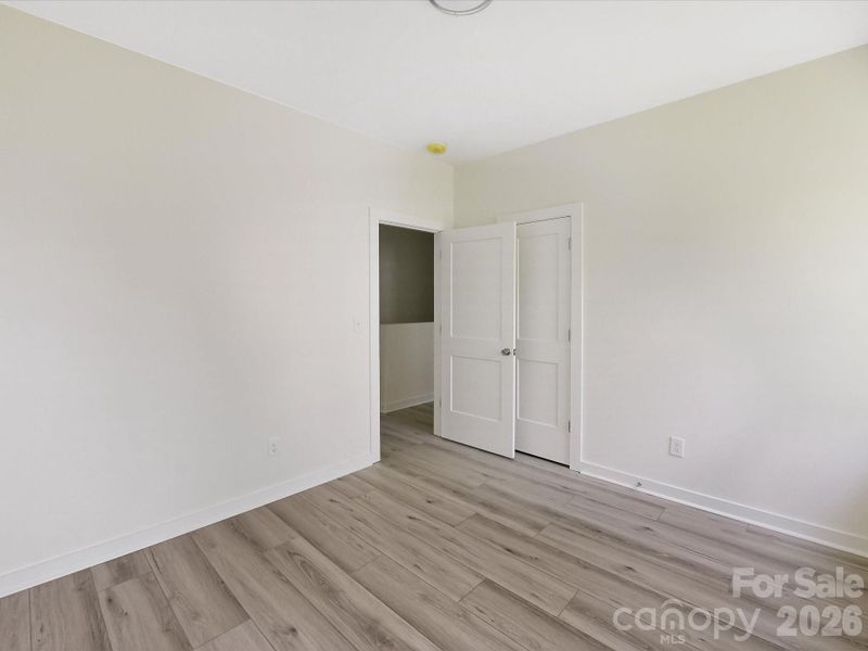 Spacious secondary bedroom features great natural light and a flexible layout, ideal for use as a guest room, home office, or cozy personal retreat.