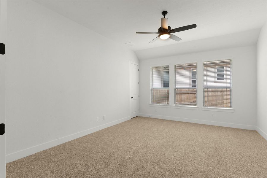 Spacious room featuring neutral carpeting and white walls Spacious room featuring neutral carpeting and white walls